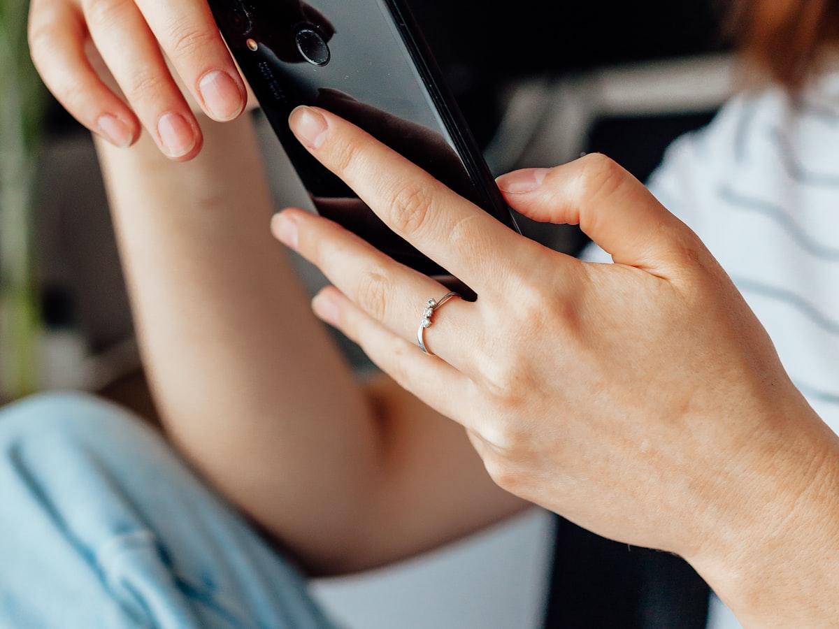Close-up of a person's hands checking a smartphone