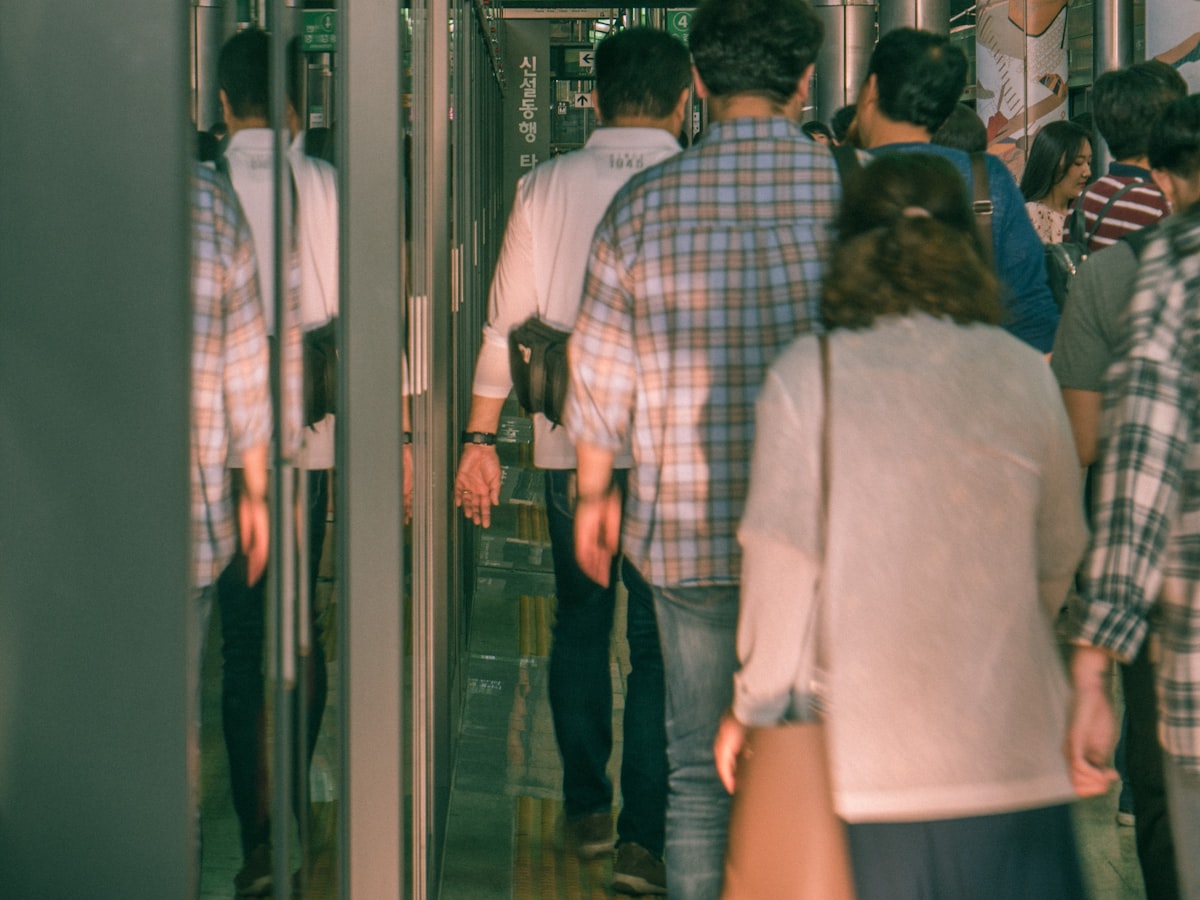 Commuters passing through the gates of a Seoul subway station, the kind of public, well-lit spot where Danggeun neighbors meet to hand over an item.