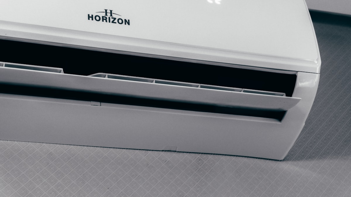 A white wall-mounted split air conditioner running indoors, the everyday cooling that drives Korea's summer electricity bill