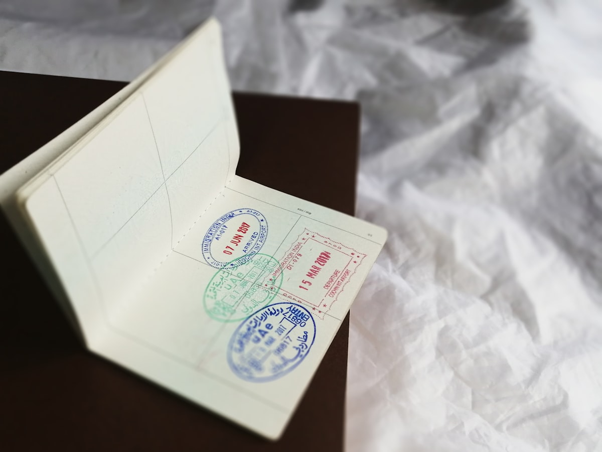 An open passport page showing several immigration arrival and departure stamps