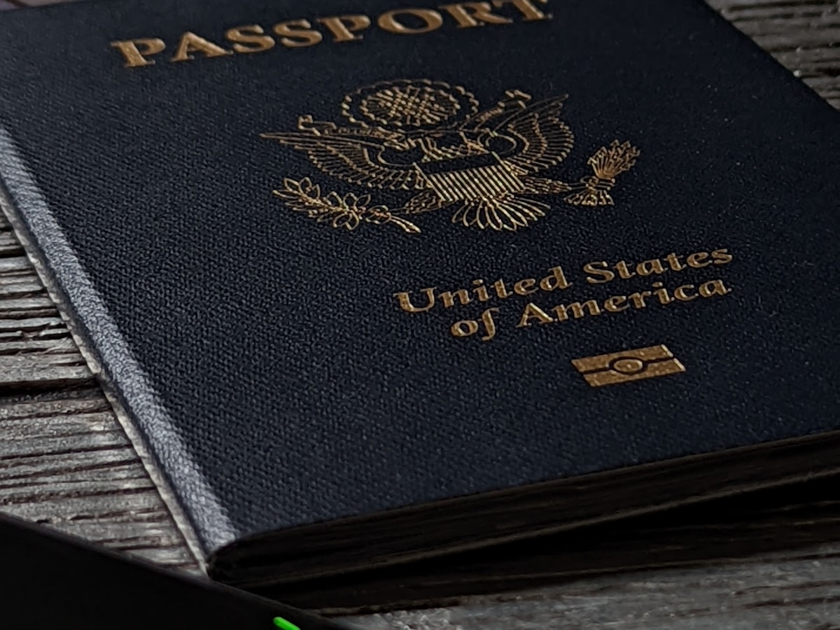 Close-up of a passport cover resting on a wooden table