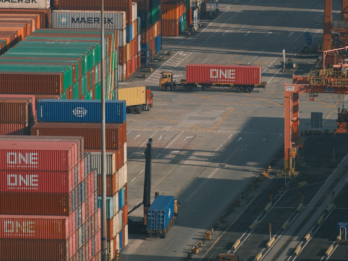 Aerial view of stacked shipping containers at a busy export port