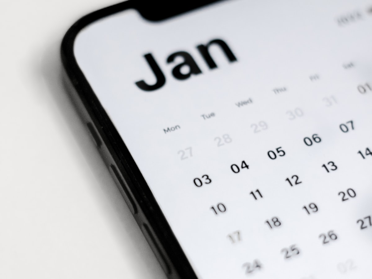 Close-up of a calendar app open on a smartphone screen, the kind of app used to check lucky moving dates