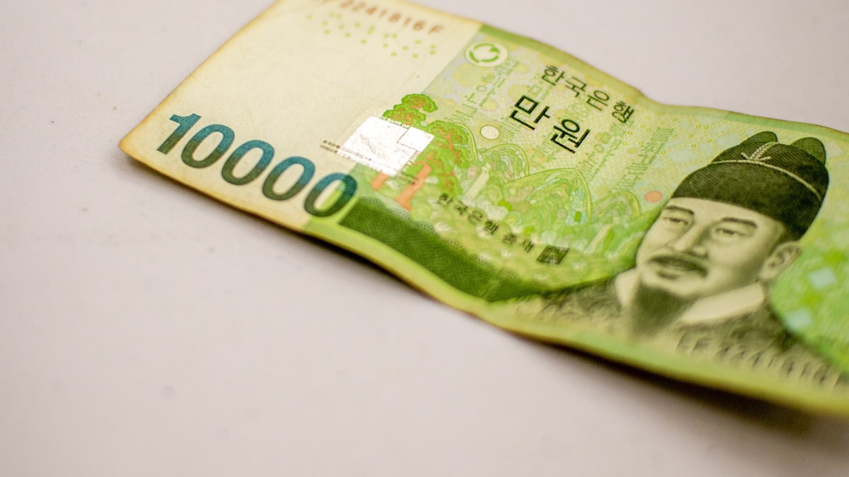 Korean 10,000 won banknote lying on a plain white surface
