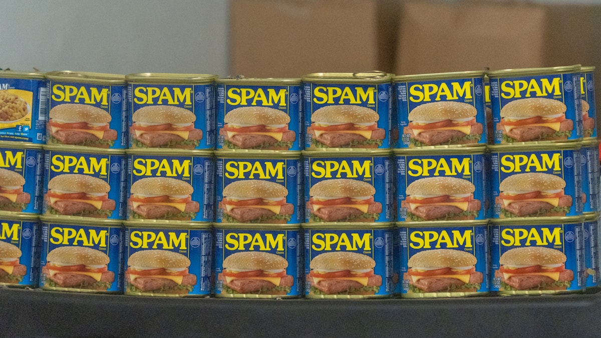 Rows of stacked blue-and-yellow SPAM cans on a display table