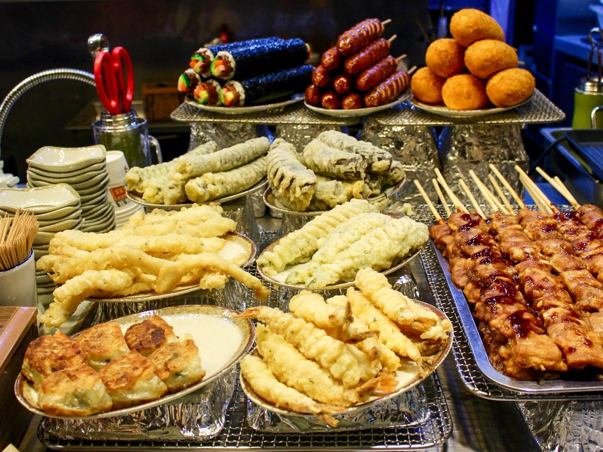 Trays of skewers and fried snacks at a Korean street food stall