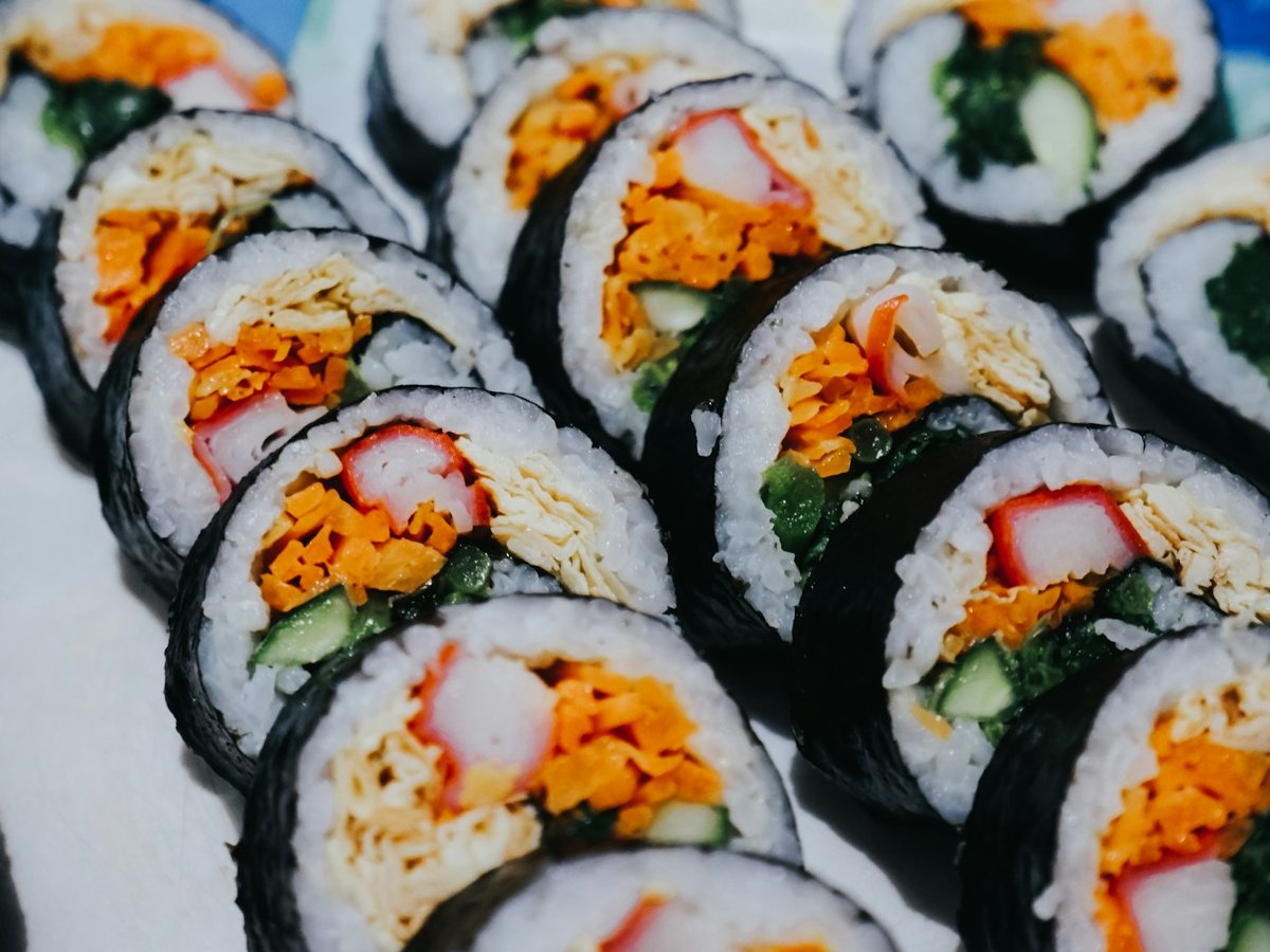 Close-up of kimbap slices with crab stick, egg and vegetables